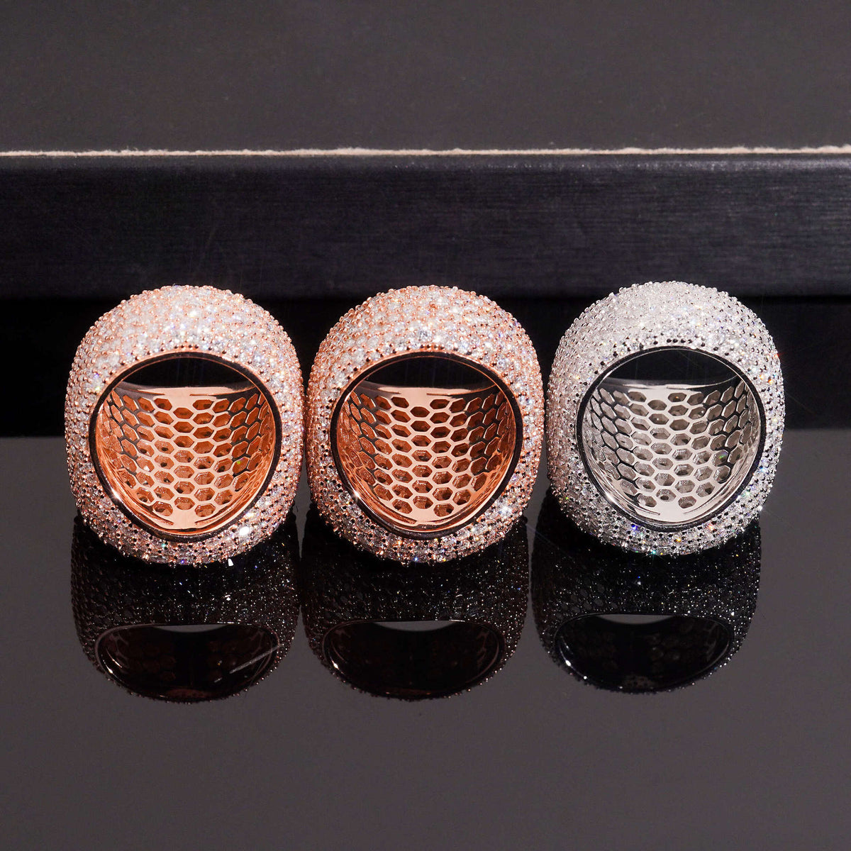 Bottom view showing hollow inner band construction of three color moissanite signet rings
