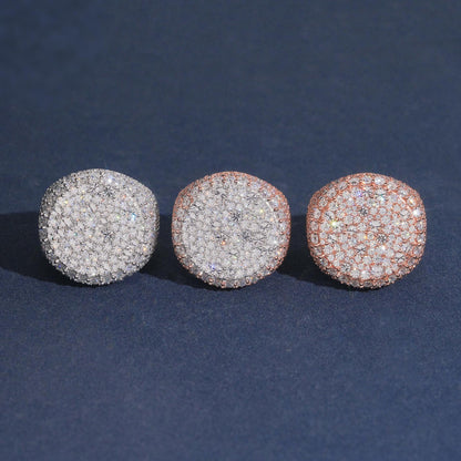 Iced out round flat top moissanite signet rings in silver rose gold and yellow gold on dark blue background