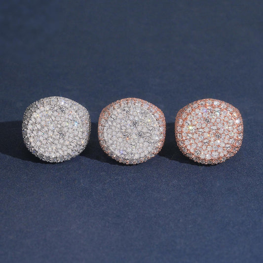 Iced out round flat top moissanite signet rings in silver rose gold and yellow gold on dark blue background