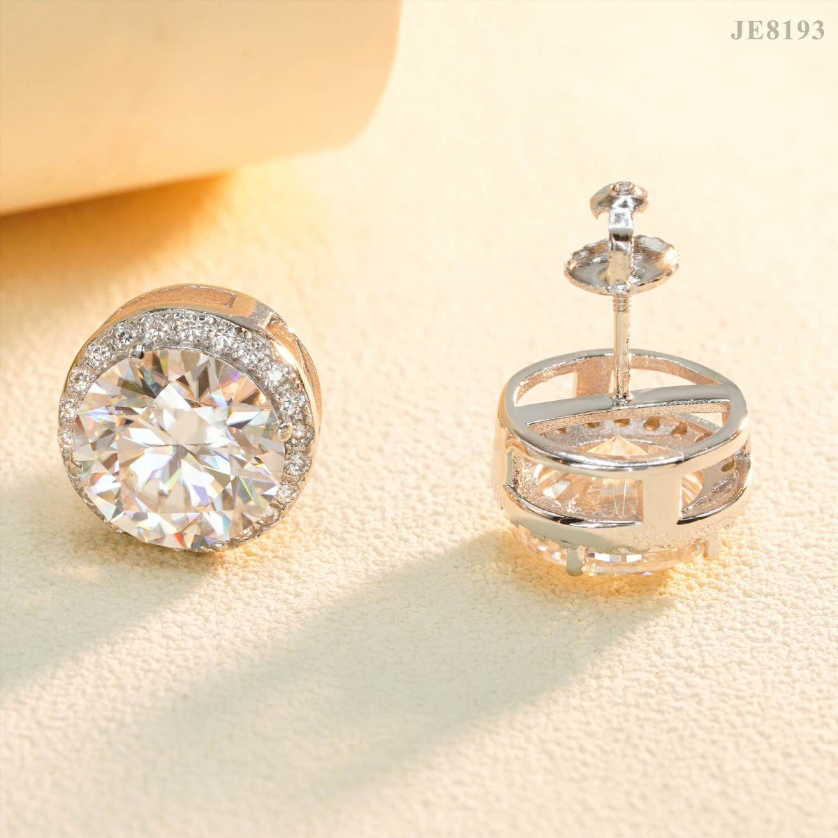 Silver iced out round solitaire halo moissanite stud earrings showing screw back post and open basket structure