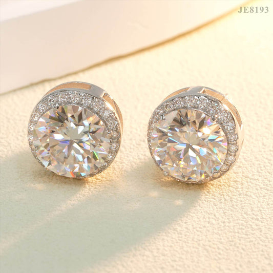 Silver iced out round solitaire halo moissanite stud earrings under warm lighting