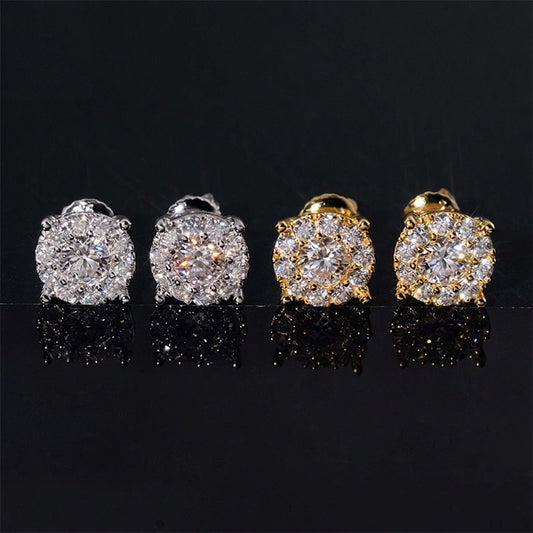 Iced out round solitaire halo moissanite stud earrings in yellow gold and silver on black reflective background