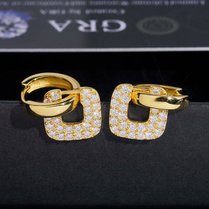 Yellow gold iced out square cushion hollow drop huggie hoop moissanite earrings with pave setting on dark background