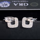 Silver iced out square cushion hollow drop huggie hoop moissanite earrings with pave setting on dark surface