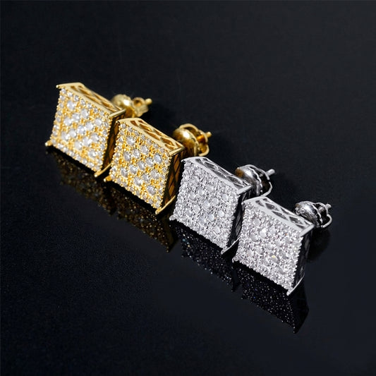 Iced out square grid moissanite stud earrings in yellow gold and silver on black reflective background