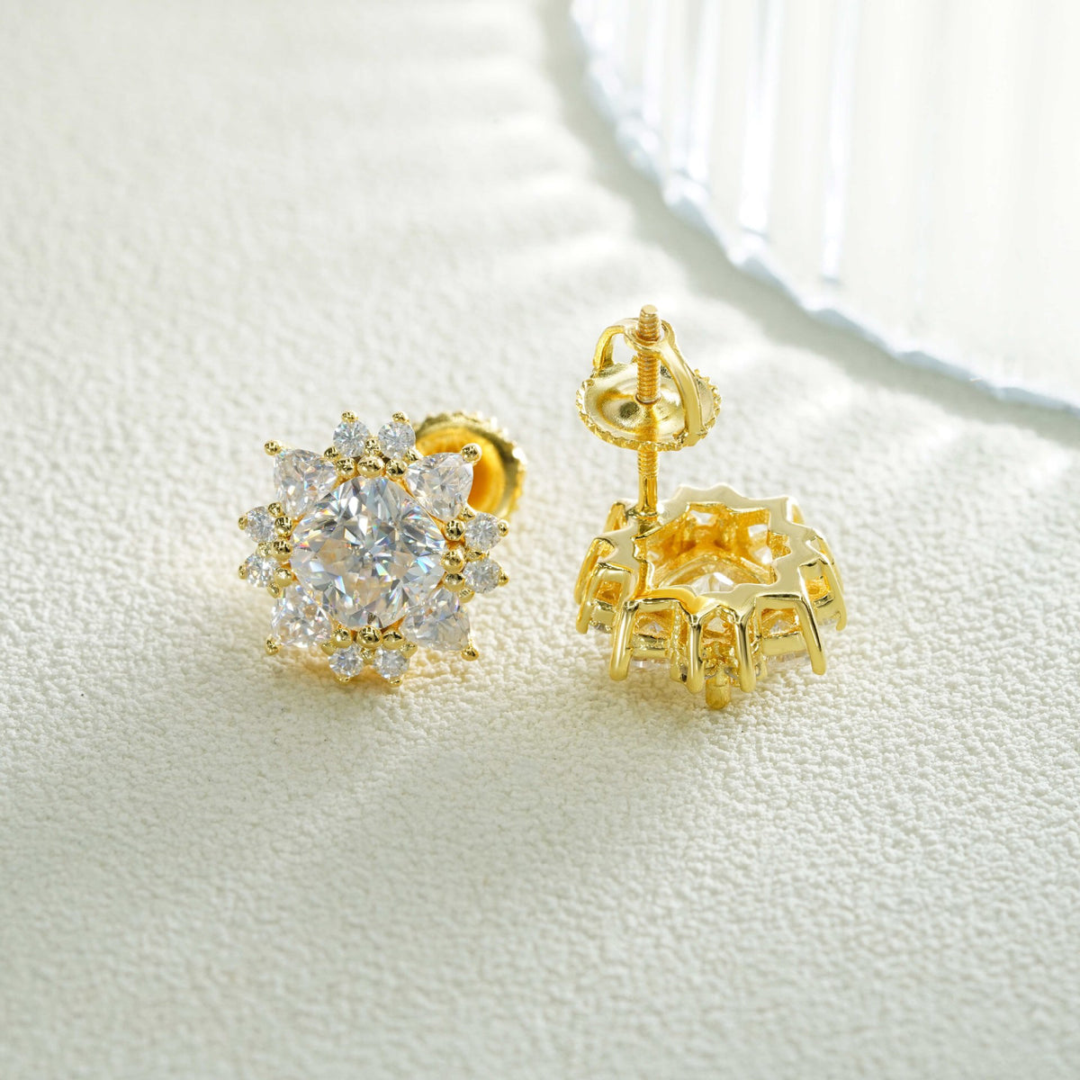 Pair of yellow gold iced out sunburst starburst solitaire moissanite stud earrings showing screw back post