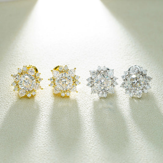 Iced out sunburst starburst solitaire moissanite stud earrings in yellow gold and silver under spotlight