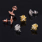 Three-tone iced out weed leaf maple leaf moissanite stud earrings showing screw back posts on black reflective surface 