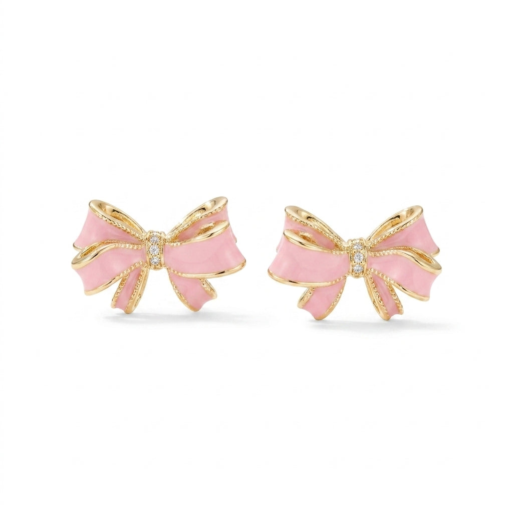 Kendra Scott x LoveShackFancy bow gold stud earrings with pink enamel and pavé crystal accents on white background.