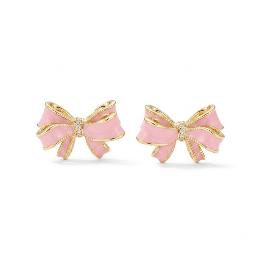Kendra Scott x LoveShackFancy bow gold stud earrings with pink enamel and pavé crystal accents on white background.