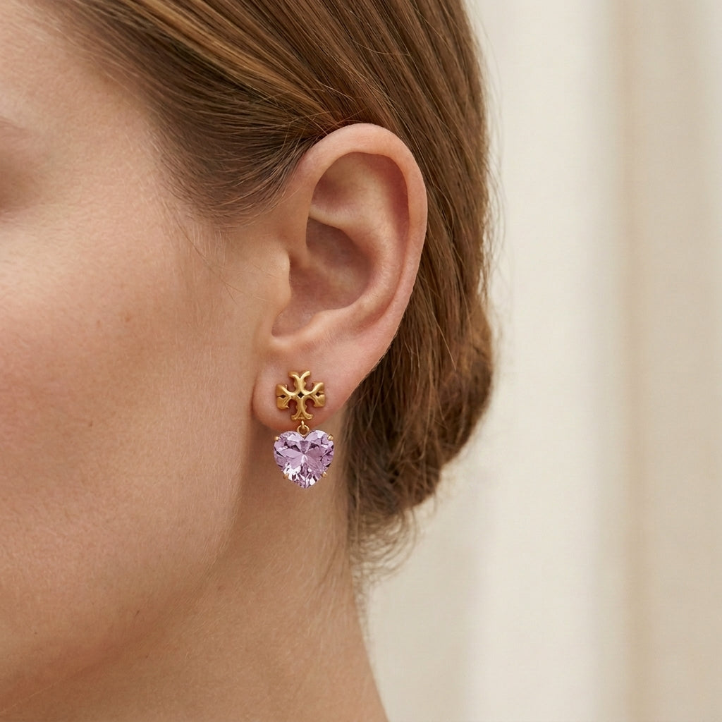 ZERRA Tory Burch gold and pink crystal heart drop earrings with sparkling gemstone accents on a white background