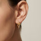 ZERRA Tory Burch Small Eleanor gold logo hoop earrings with monogram design, showcasing sleek, elegant jewelry style.