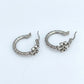 ZERRA Tory Burch Small Eleanor gold logo hoop earrings with monogram design, featuring a classic hoop style and polished finish.