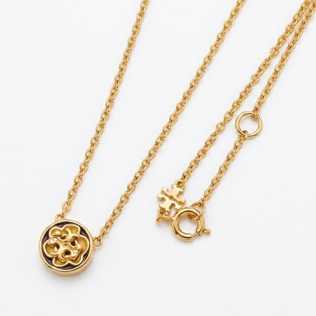 Zerra Jewelry Tory Burch Kira Flower Gold Pendant Necklace with floral chevron design, featuring a delicate gold chain and pendant.