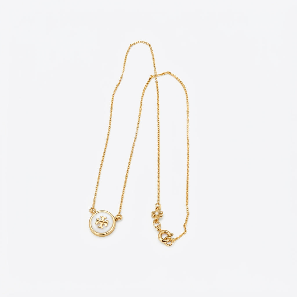 Zerra Jewelry Tory Burch Kira enamel pendant necklace in color block with gold-tone chain and multicolor enamel accents.