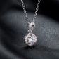 Round diamond infinity knot halo pendant necklace displayed on dark background.