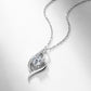 Angled layflat view of round diamond intertwined swirl pendant necklace on white background.