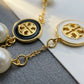 Close-up of the Tory Burch bracelet highlighting the pearl luster and polished gold chain links