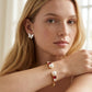 Model wearing Kate Spade Pearls of Wisdom Red Bracelet, a chic statement for daily luxury