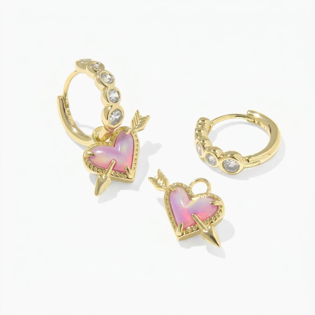 Kendra Scott Ari heart earrings demonstrating the removable charm and plain crystal huggie hoop option.