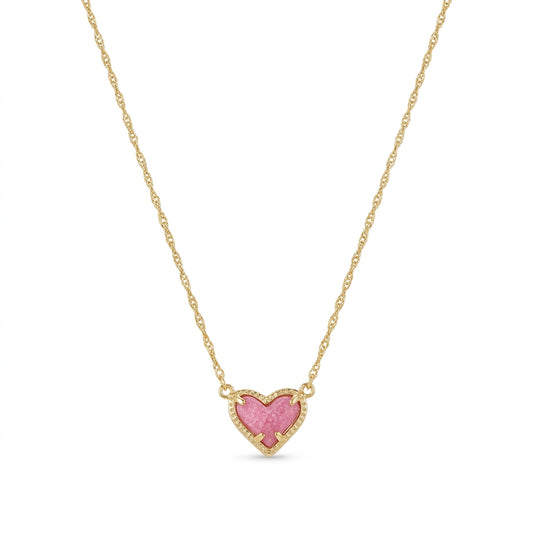 Kendra Scott Ari Heart short pendant necklace in gold featuring an asymmetrical pink stone charm.