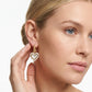 Model wearing Ari Heart Gold Huggie Earrings, a romantic minimalist jewelry statement