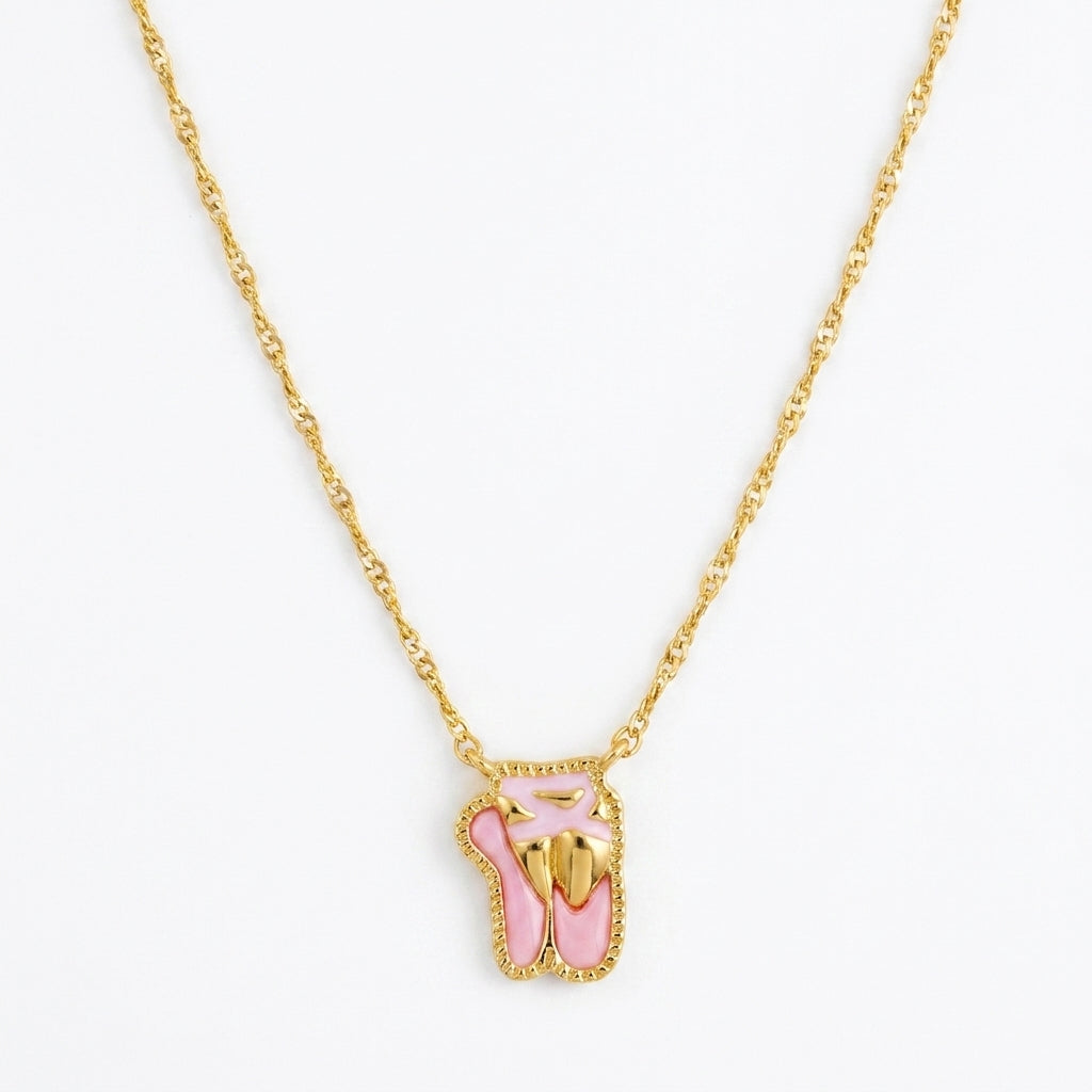 Kendra Scott Ballet short pendant necklace in gold featuring pink enamel ballet slippers charm.