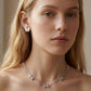 Model wearing Kendra Scott Silver Bow Necklace, a chic accessory for trendy minimalist outfits