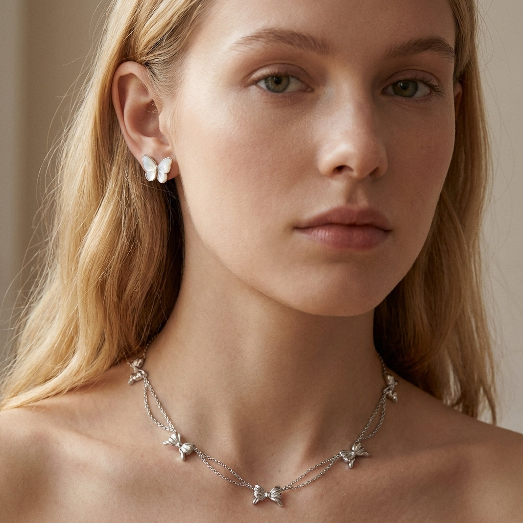 Model wearing Kendra Scott Silver Bow Necklace, a chic accessory for trendy minimalist outfits