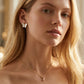 Model turns and smiles wearing Kendra Scott Candy Cane Necklace, capturing the festive shimmer