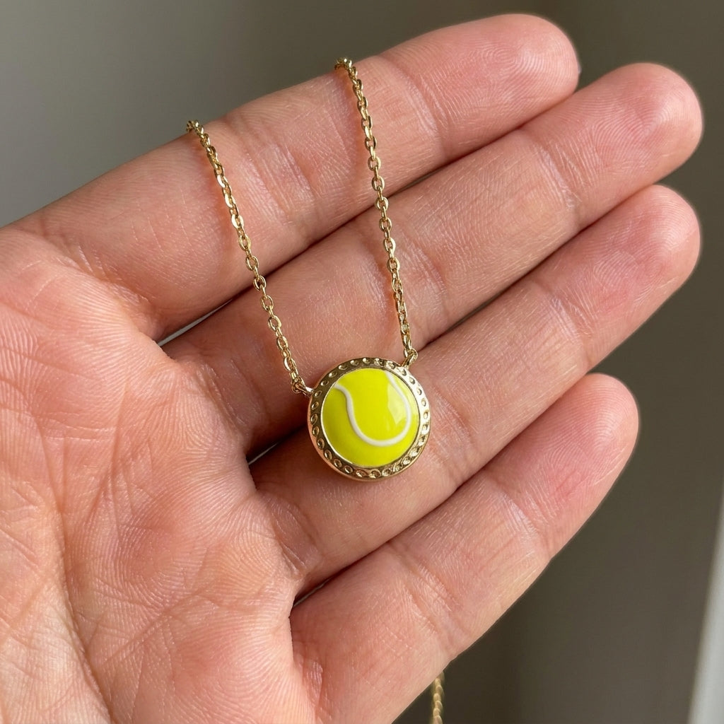Close-up of a hand holding the gold Kendra Scott tennis necklace to show the natural chartreuse magnesite texture.