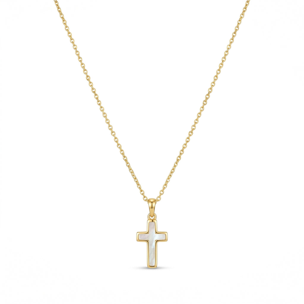 Kendra Scott cross pendant necklace in gold with an inlaid white stone on a white background