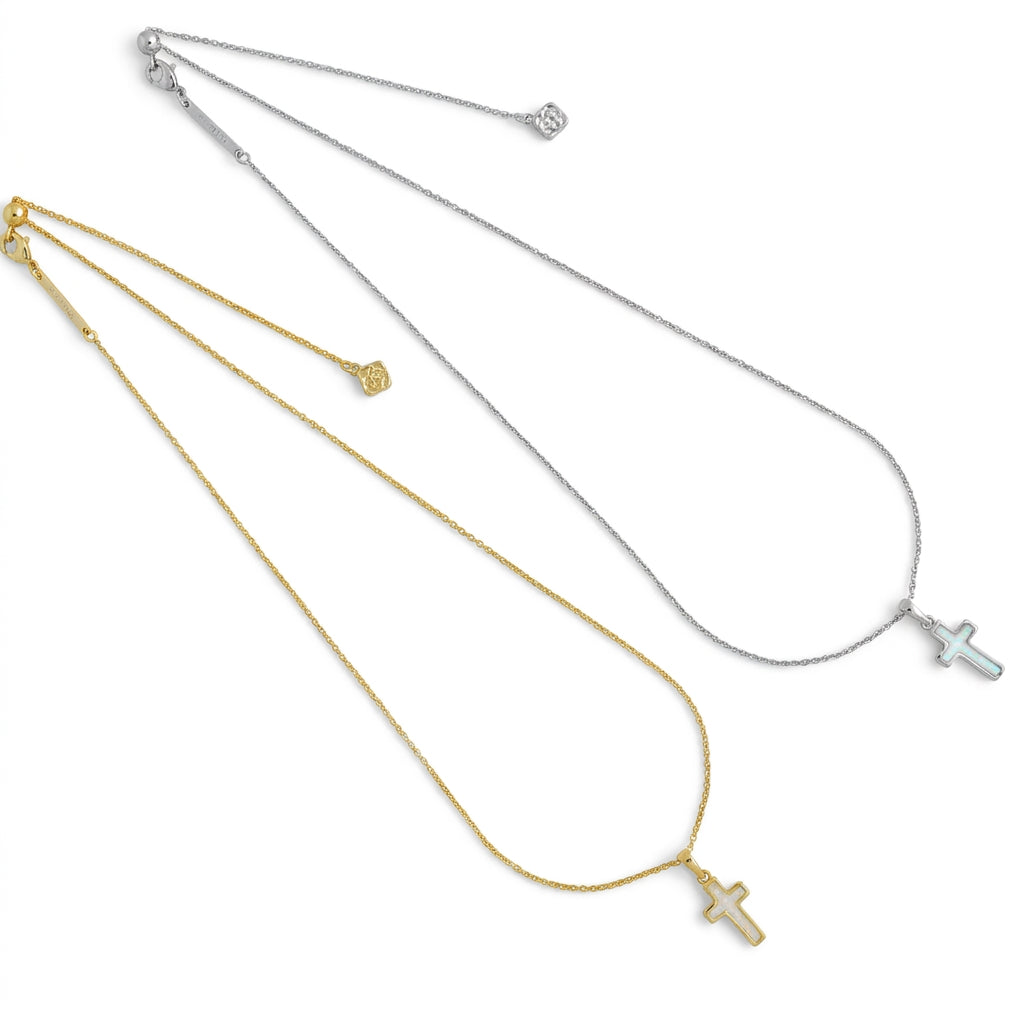 Two Kendra Scott cross pendant necklaces displayed together in yellow gold and silver options