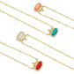 A collection of four Kendra Scott x Disney Elisa Princess crown necklaces in red, green, pink, and white options.