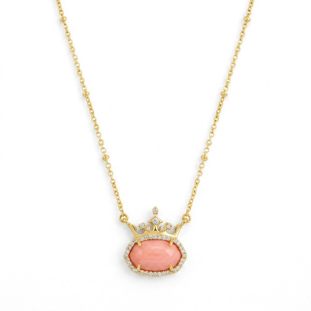 Kendra Scott x Disney Elisa Princess gold crown necklace featuring a soft coral pink stone.
