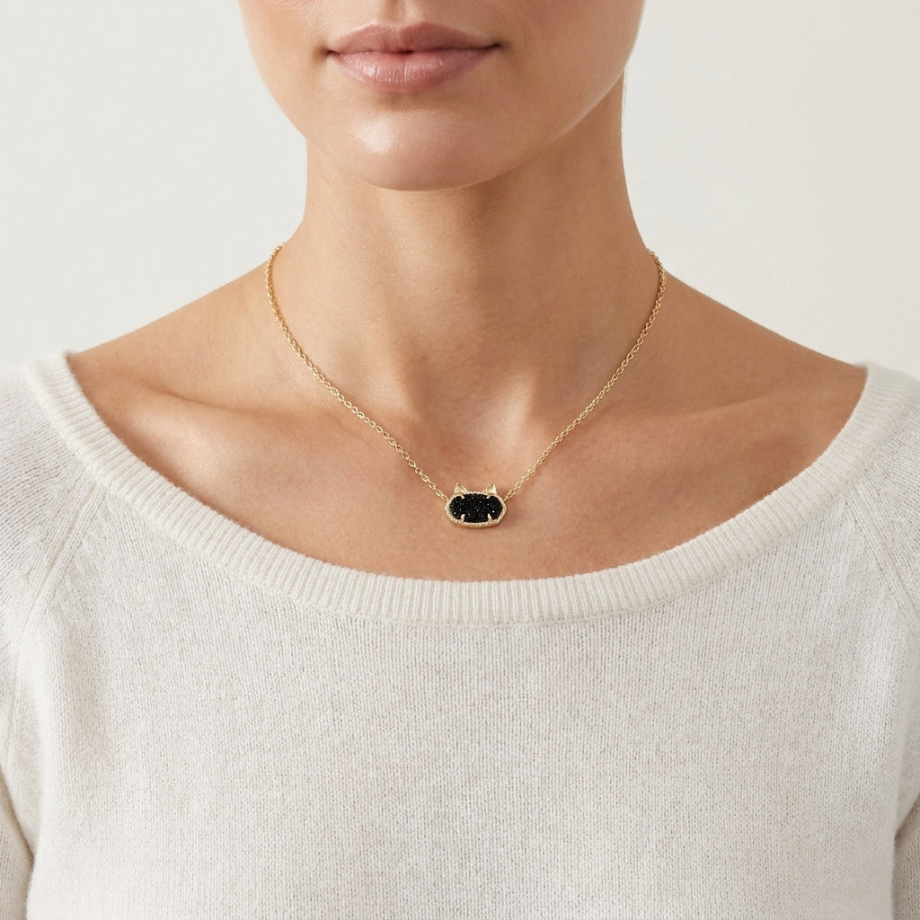 Front view of a model wearing the Kendra Scott Elisa cat gold pendant necklace in black to demonstrate length and proportions.
