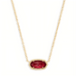 Kendra Scott Elisa gold pendant necklace with a brilliant faceted ruby red gemstone.