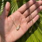 Hand-held size reference of the Kendra Scott gold Golf Necklace to show the delicate scale