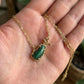 Hand-held size reference of the Kendra Scott Golf Necklace to show the delicate pendant scale