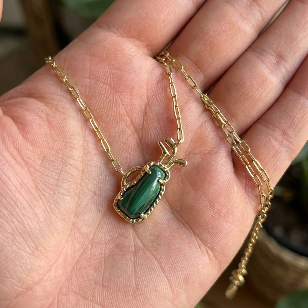 Hand-held size reference of the Kendra Scott Golf Necklace to show the delicate pendant scale