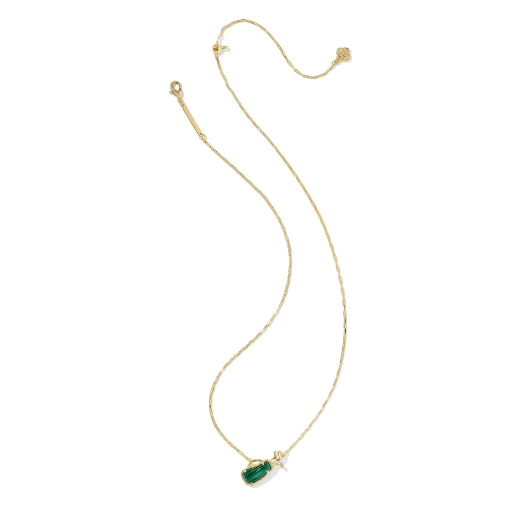 Macro detail of the gold golf pendant necklace showing the polished finish and crystal accent