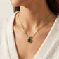 Model wearing Kendra Scott Holiday Tree Necklace, a festive minimalist accessory for the season
