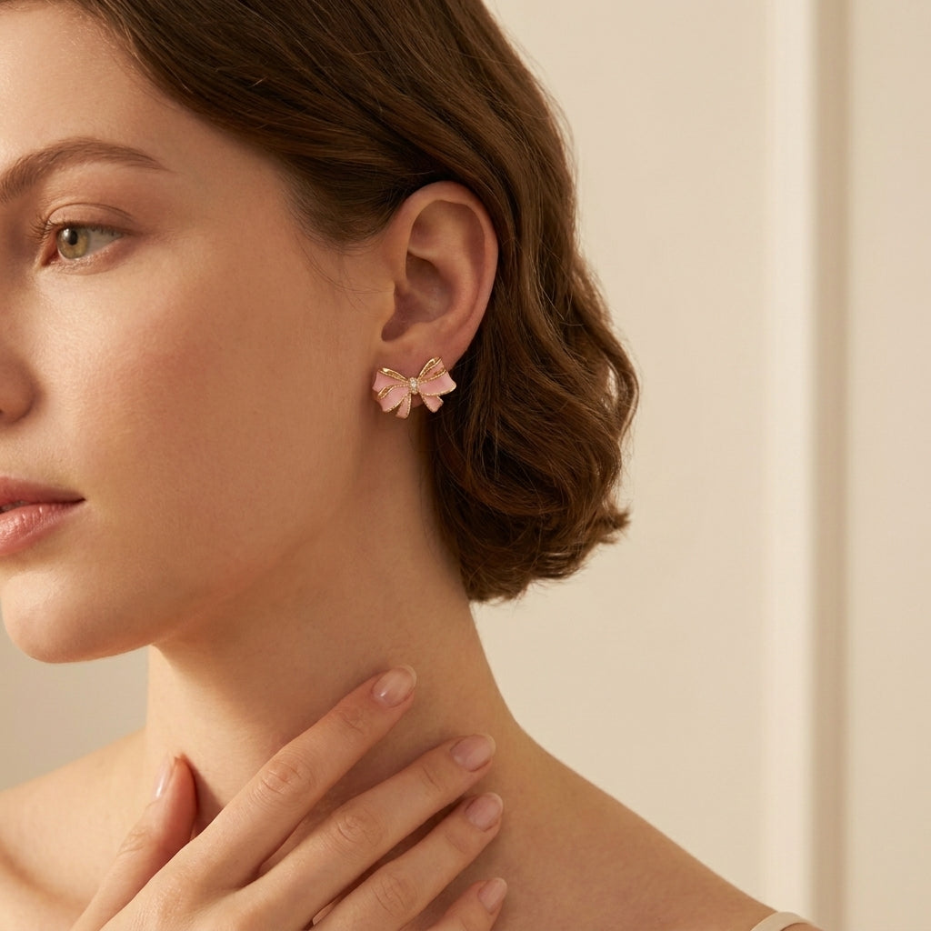 Side profile of a brunette woman wearing the Kendra Scott x LoveShackFancy pink bow earrings.
