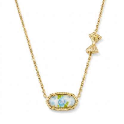 Kendra Scott x LoveShackFancy Elisa Marie gold pendant necklace featuring a blue floral rose print stone and asymmetrical bow detail