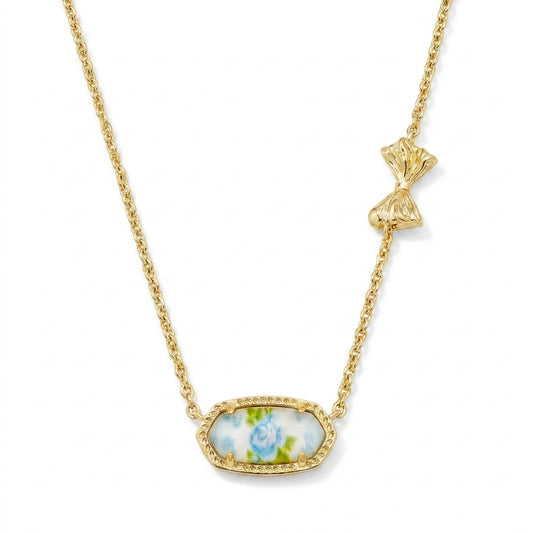 Kendra Scott x LoveShackFancy Elisa Marie gold pendant necklace featuring a blue floral rose print stone and asymmetrical bow detail