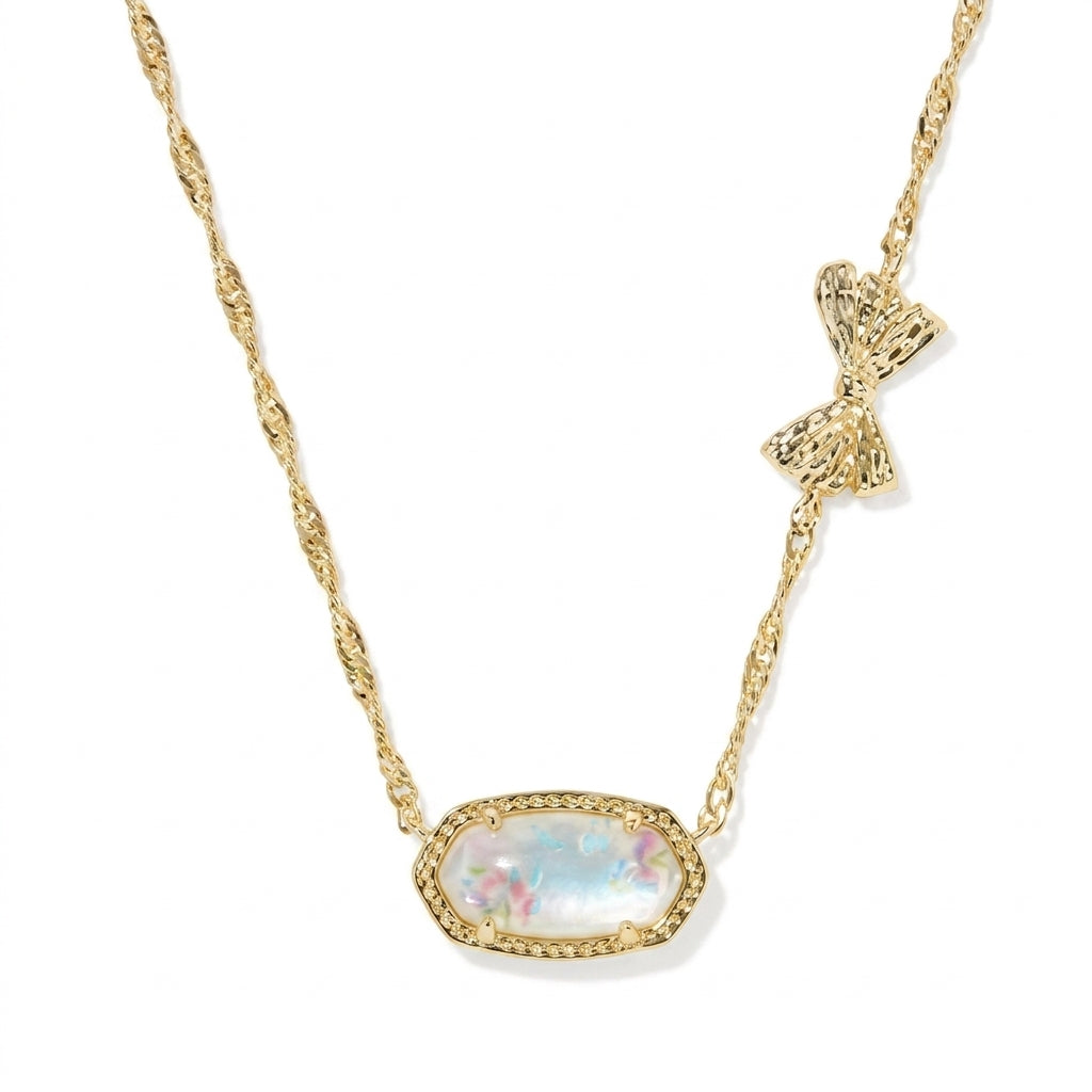 Kendra Scott x LoveShackFancy blue floral necklace featuring a gold bow charm on the twist chain.