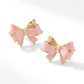 Side view of Kendra Scott x LoveShackFancy gold bow stud earrings featuring light pink enamel coating.