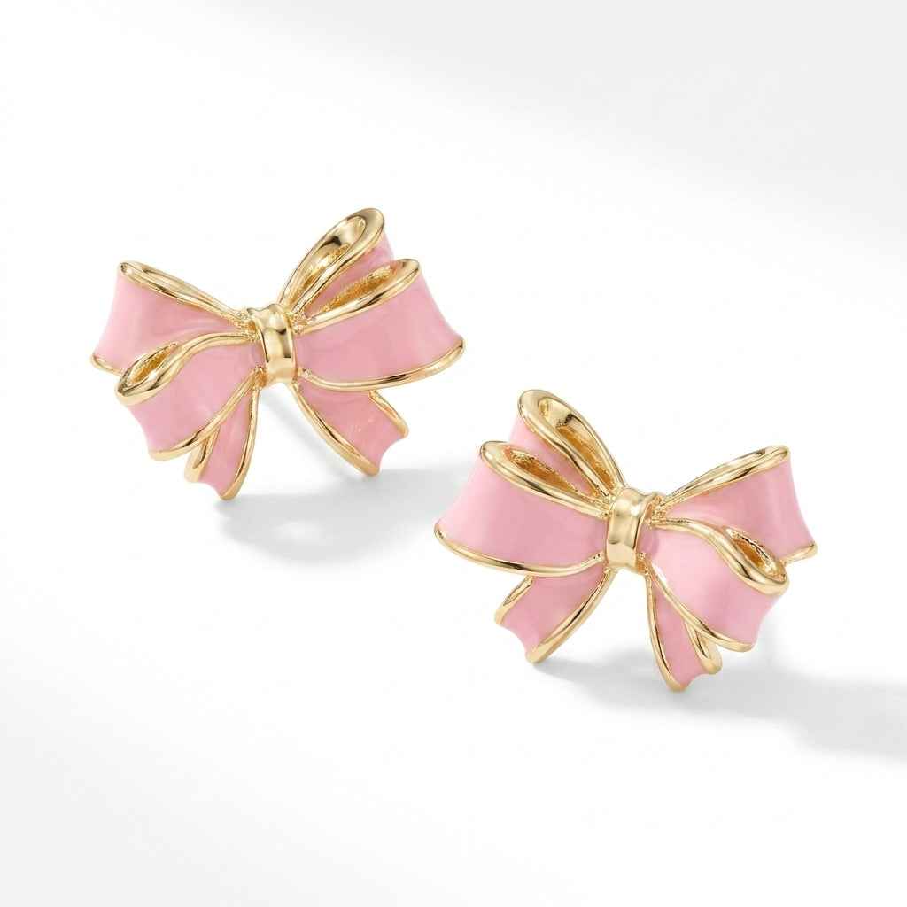 Side view of Kendra Scott x LoveShackFancy gold bow stud earrings featuring light pink enamel coating.