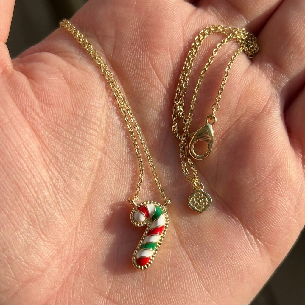 Hand-held size reference of the multicolor Candy Cane Necklace to show the delicate pendant scale