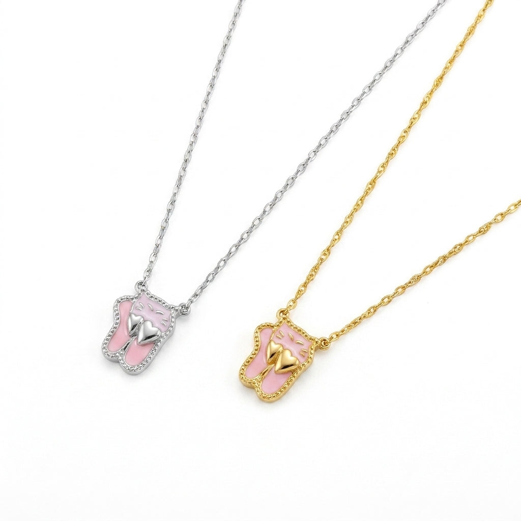 Close-up view of the gold and silver Kendra Scott pink enamel ballet slippers charms.